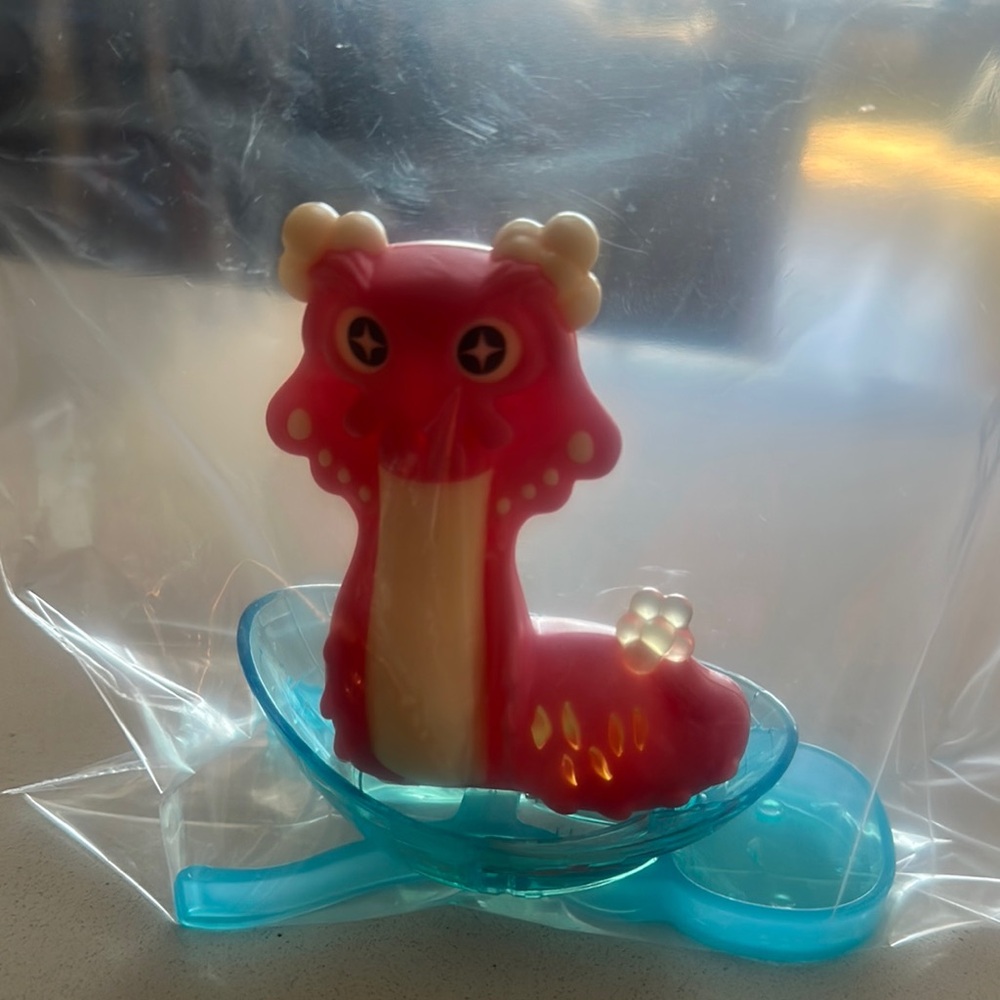 Red and Cream Dragon Figurine with Blue Base